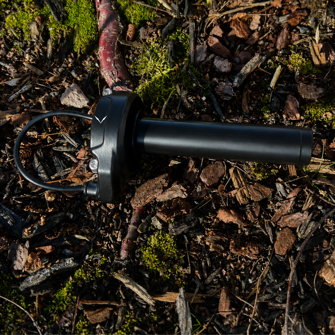 Waterproof plug connector and wiring harness on the Velterra black e-bike throttle.