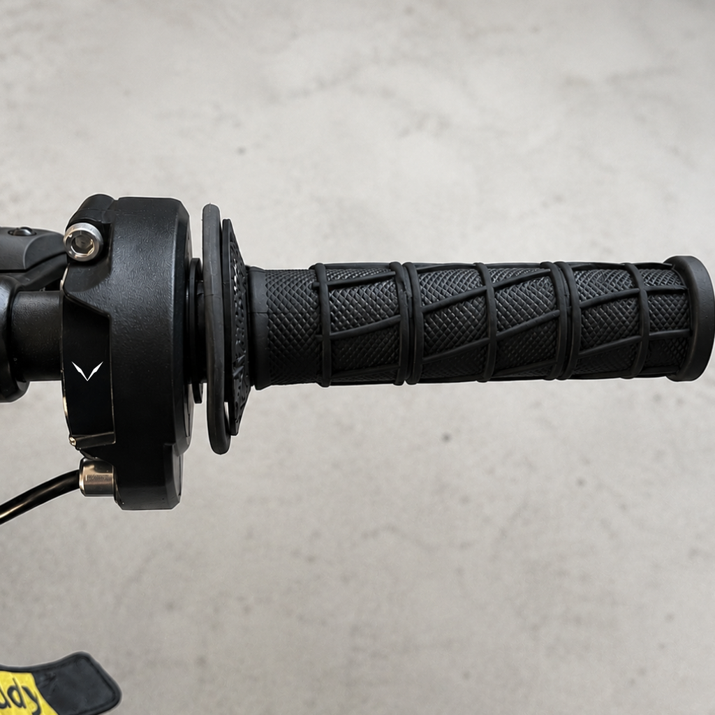 Velterra black twist throttle installed neatly on e-moto handlebars next to the brake lever.