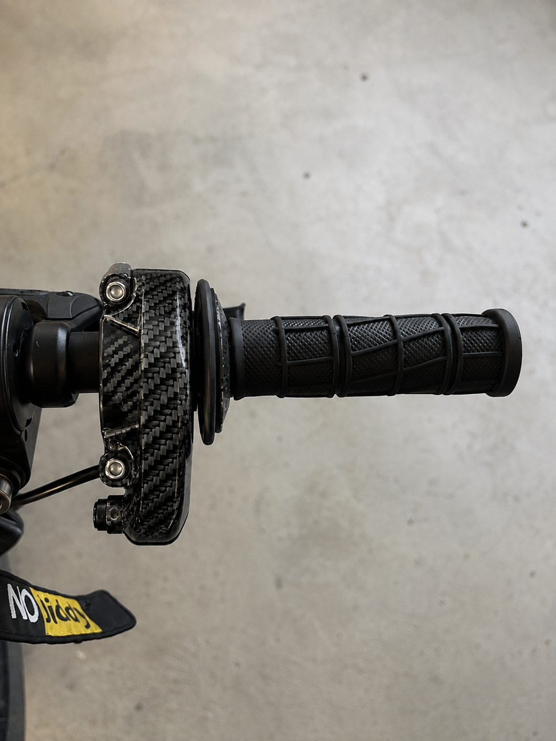 Step-by-step view of the Velterra carbon fibre throttle being installed onto handlebars.
