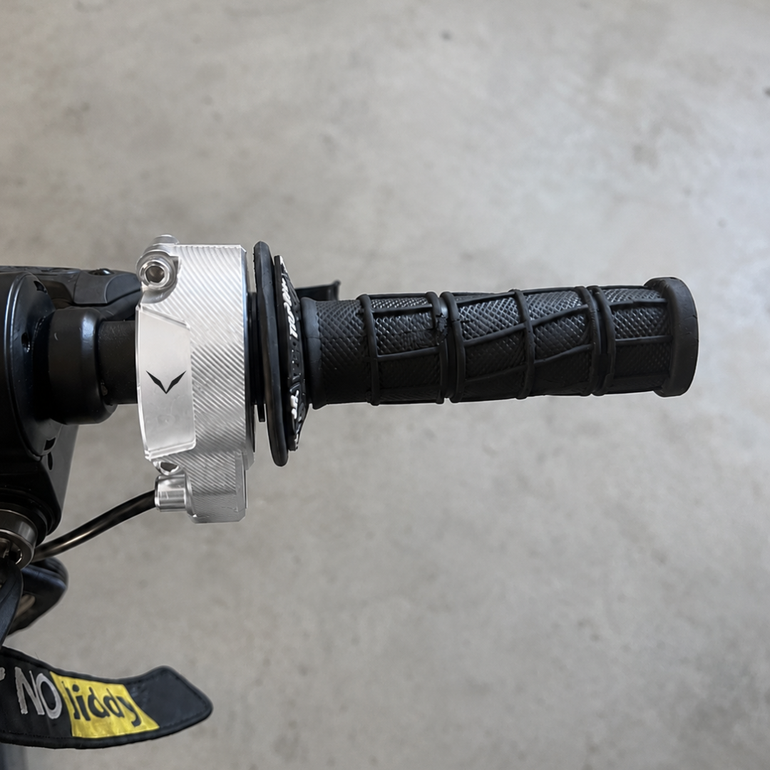Velterra twist throttle installed on e-bike handlebars next to brake levers.