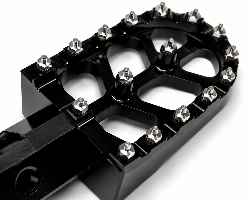 Detailed close up view of aggressive steel grip teeth on Velterra aftermarket footpegs.