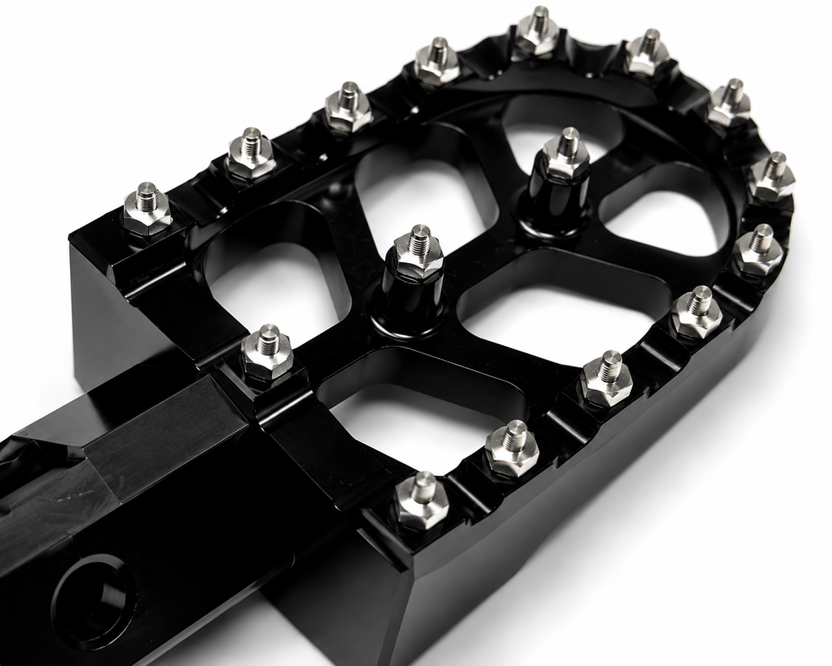 Detailed close up view of aggressive steel grip teeth on Velterra aftermarket footpegs.